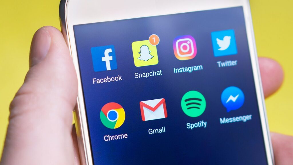 Social media icons displaying on a phone screen, illustrating how social medica can impact your personal injury case.
