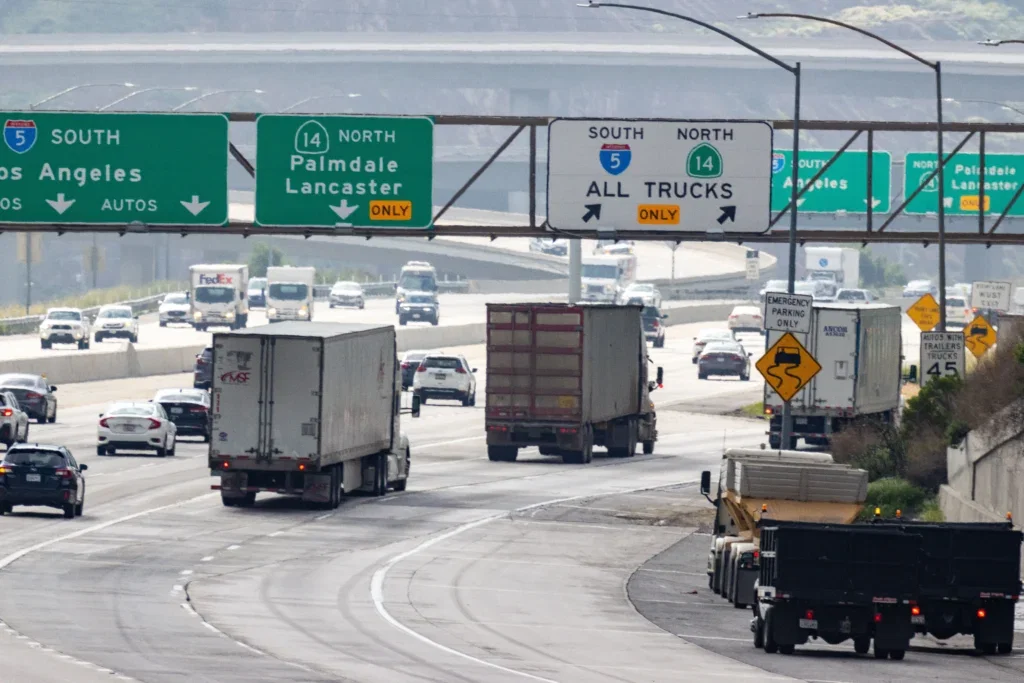 Trucks navigating a Los Angeles freeway, illustrating who is liable in a truck accident.