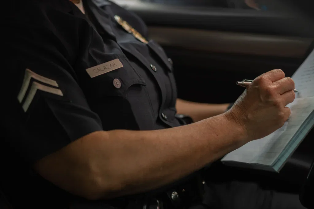 A police officer filling out a wrong police report.