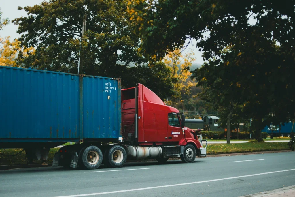 Truck Driving Down a Road A freight truck driving down the road, illustrating the truck accident damages available should an accident occur.