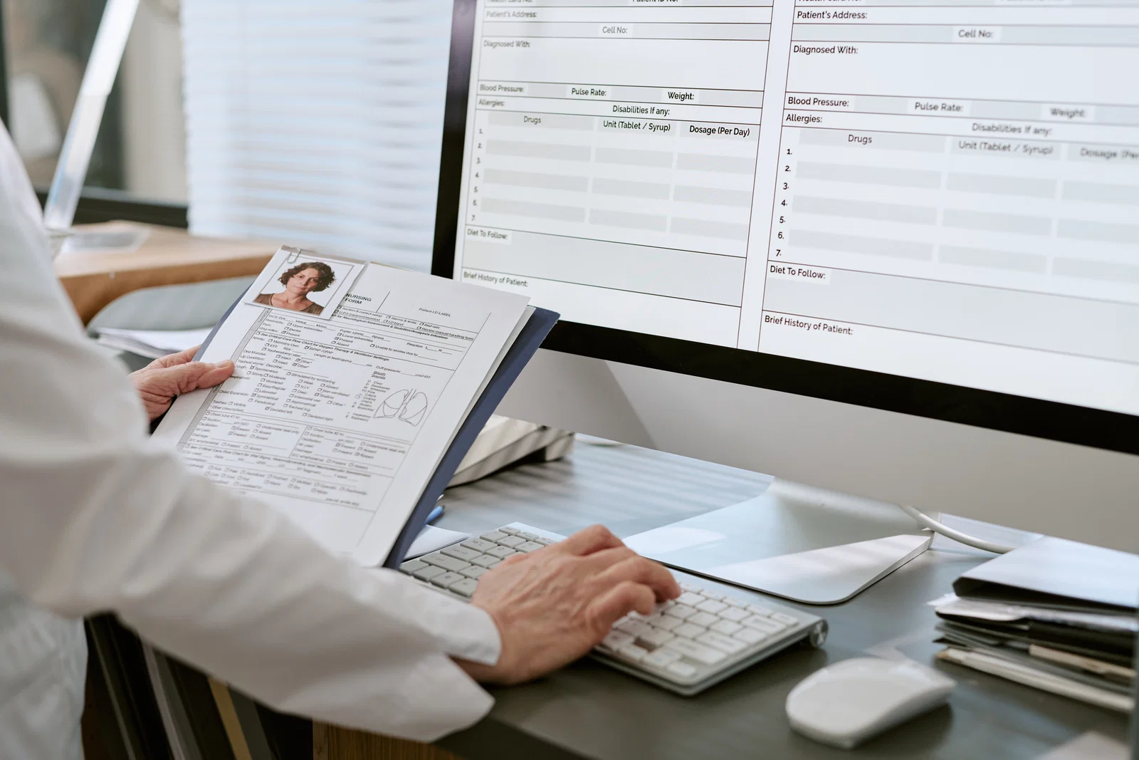 A doctor checking a patient's medical chart for pre-existing injuries.
